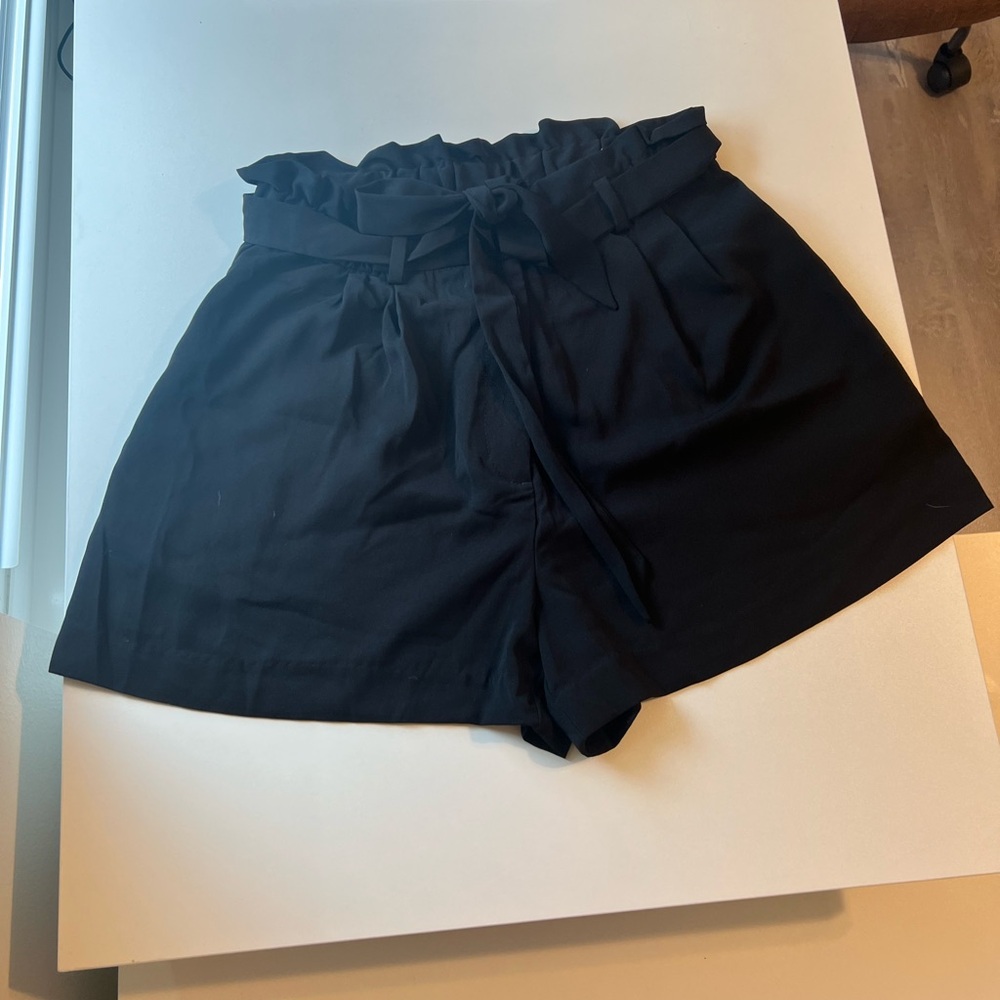 High waisted, black tie front shorts. Elastic waistband in back